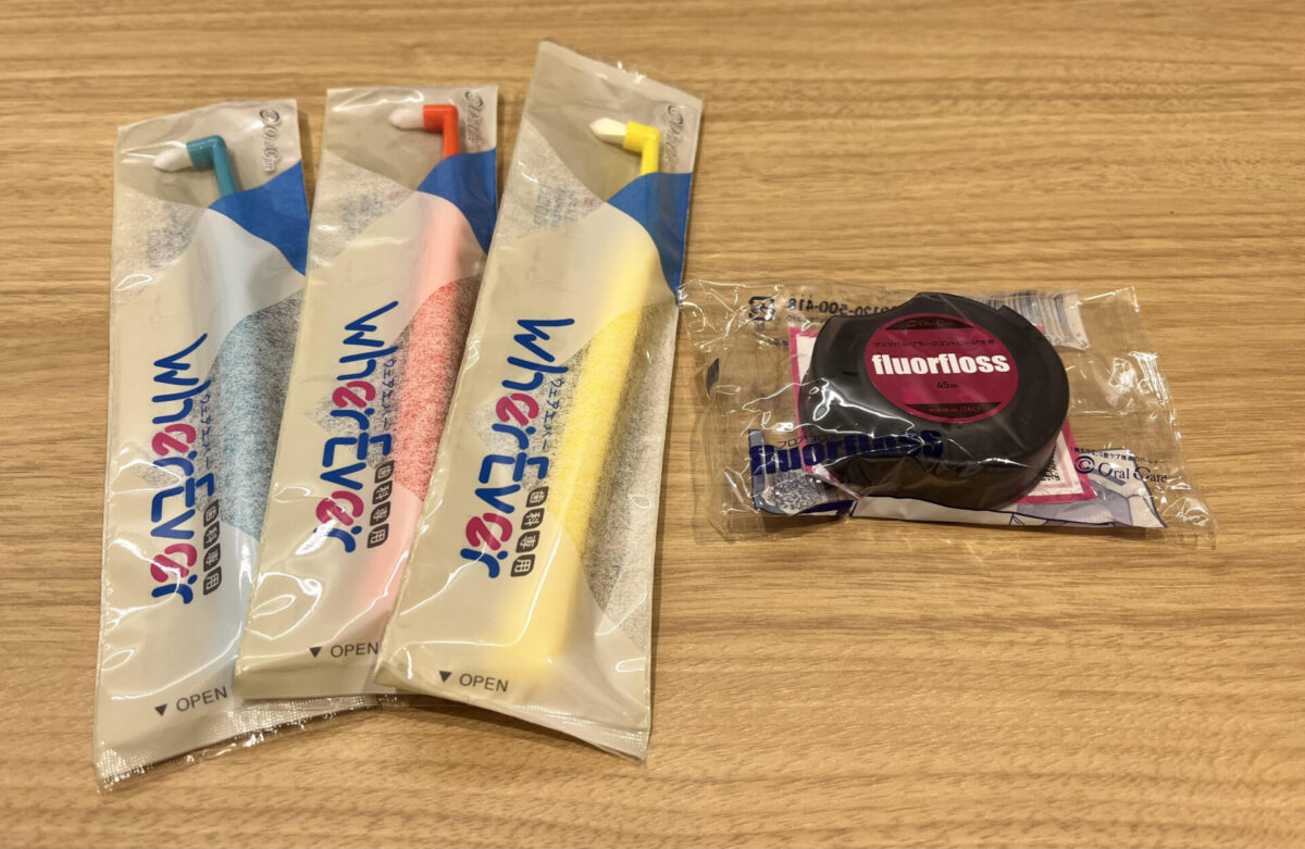 3本のワンタフトブラシとデンタルフロスを並べた写真